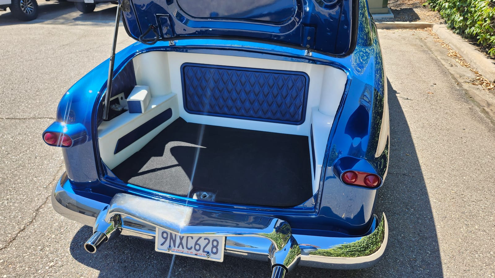 Candy blue classic car trunk with custom audio amp rack and diamond-stitch upholstery, Escondido